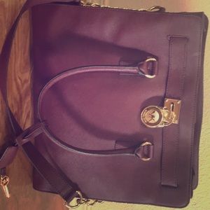 Merlot colored Michael Khor purse large. Gold
